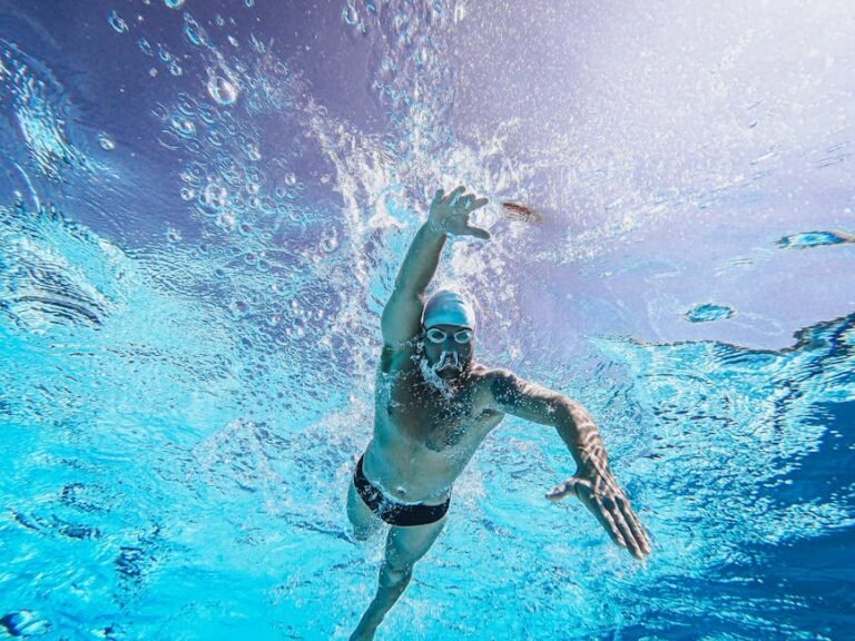 A focused triathlete standing by the open water, mentally preparing and visualizing their race to conquer pre-race nerves