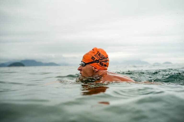 Triathlete performing high-intensity open water swim workouts in a choppy lake
