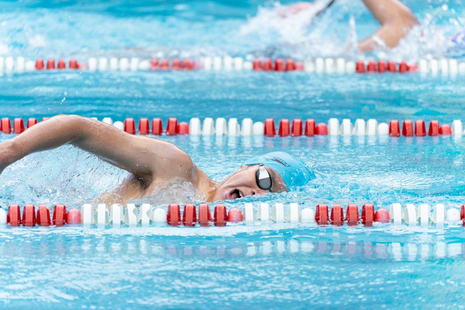 Swimmer adjusting goggles before open water practice