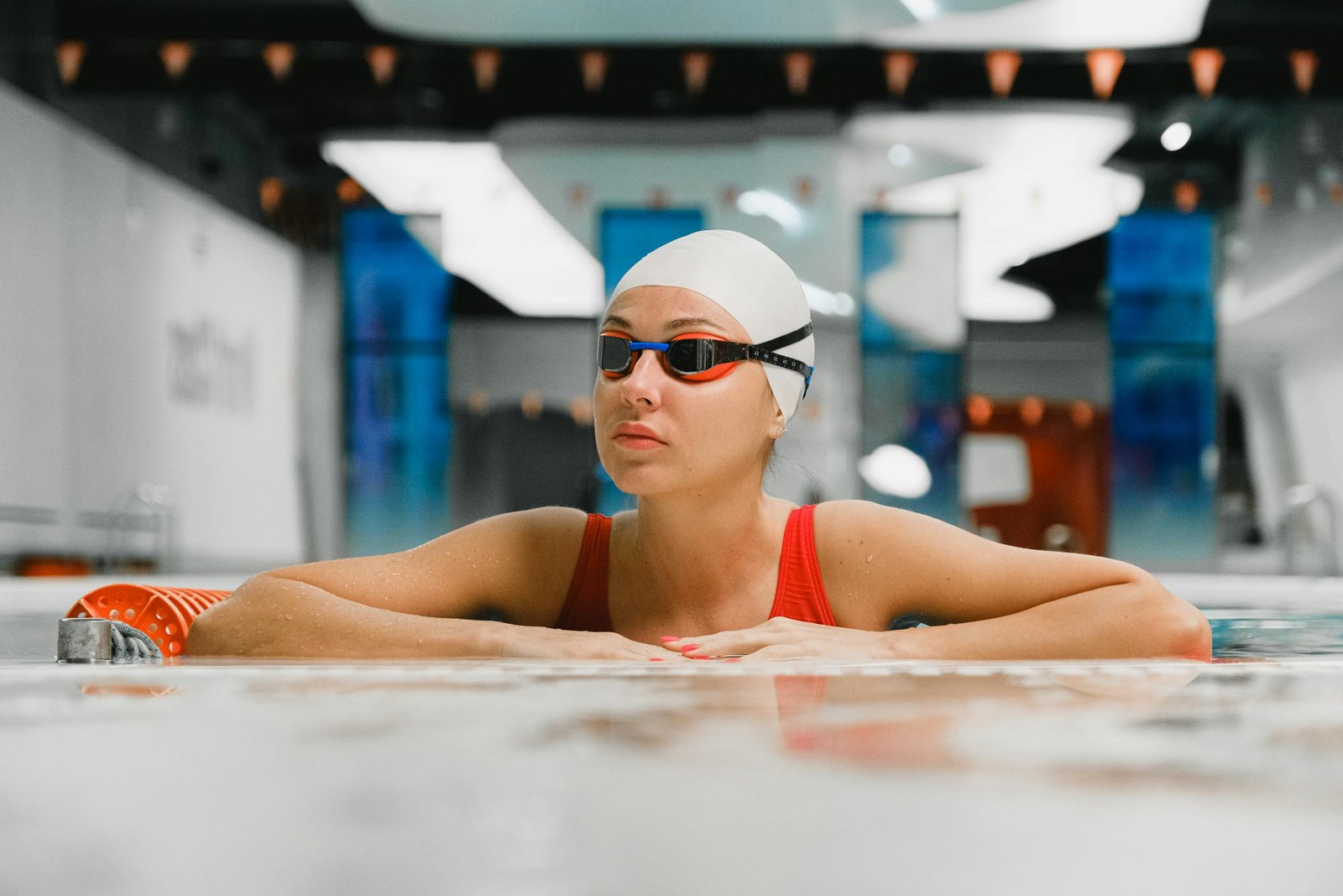 Swimmer wearing goggles in an outdoor pool on a sunny day