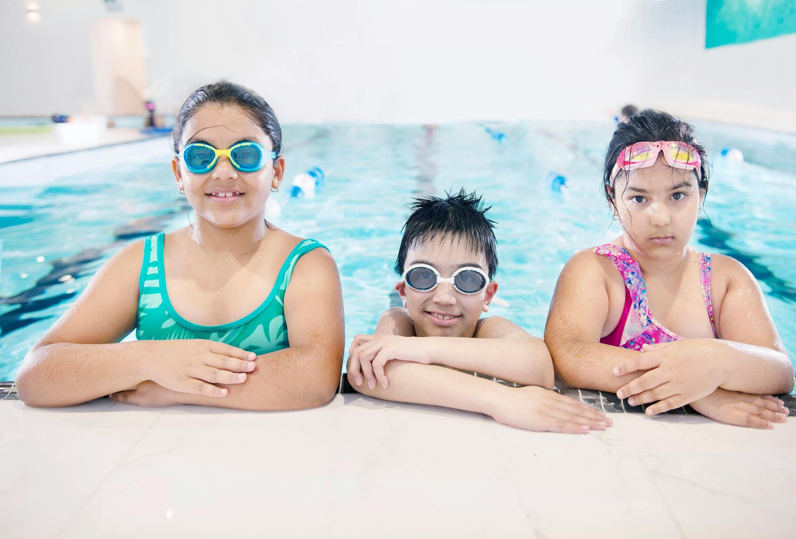 Child wearing swim goggles during pool practice