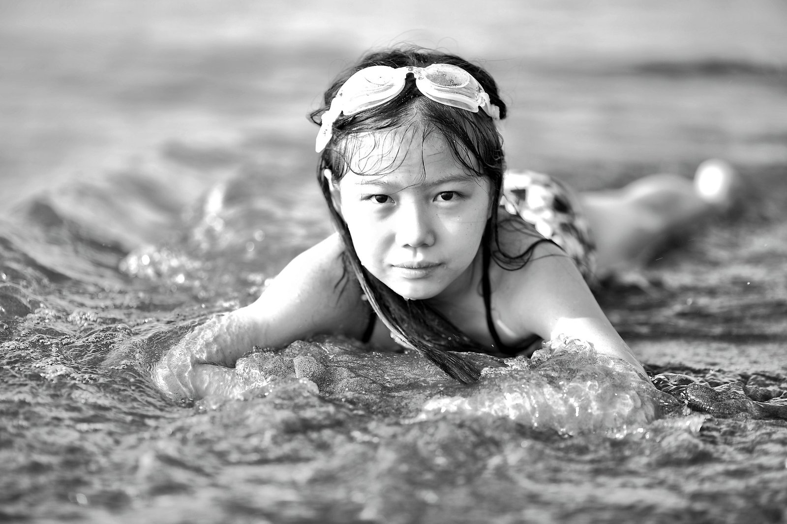 Swimmer adjusting goggles before pool training with a smaller face fit