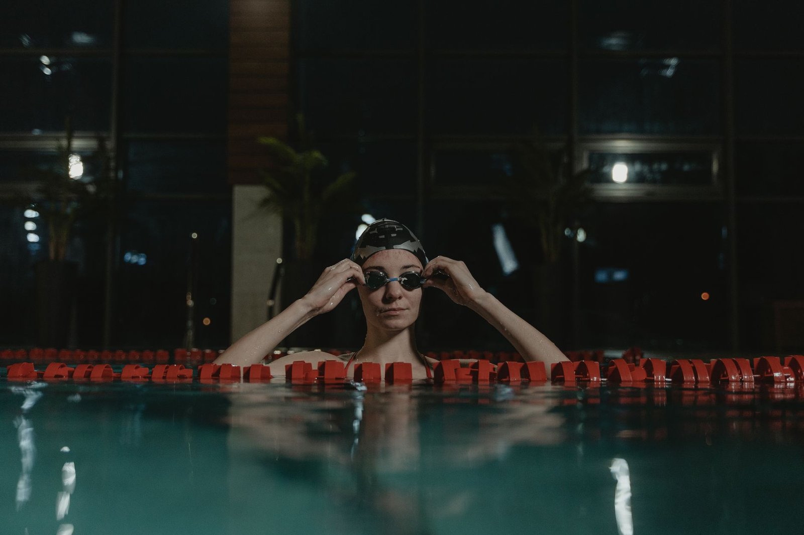 Open water swimmer adjusting goggles before swim start