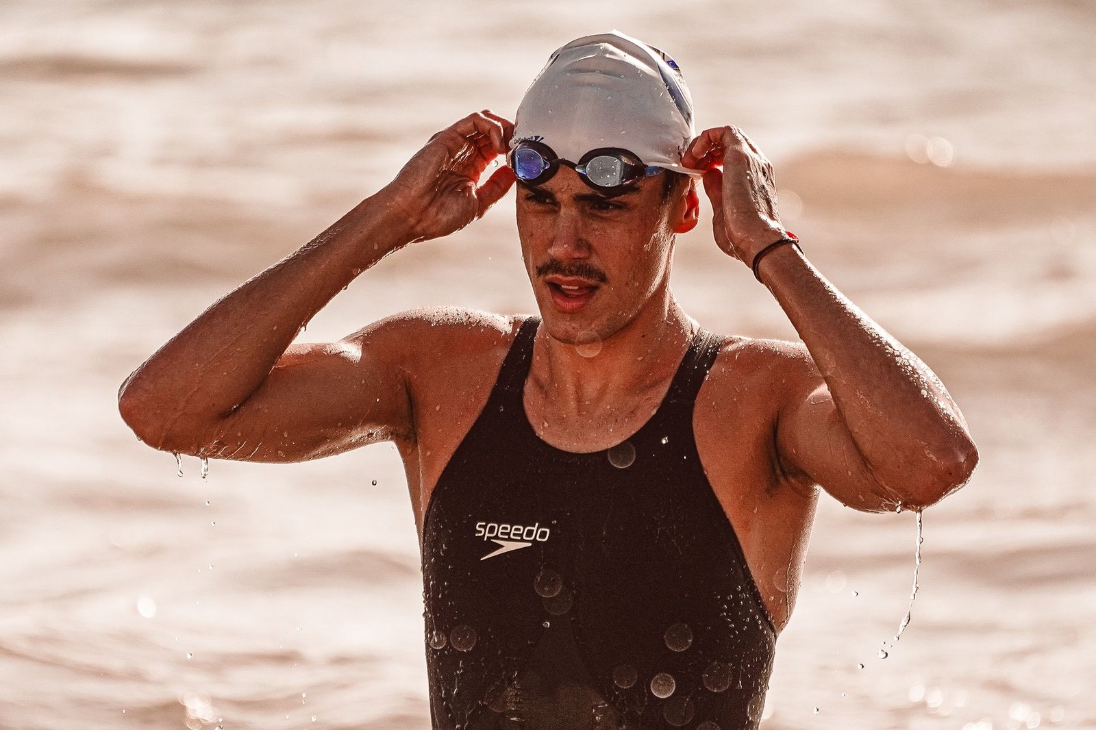 Triathlete wearing open water goggles during an Ironman swim race