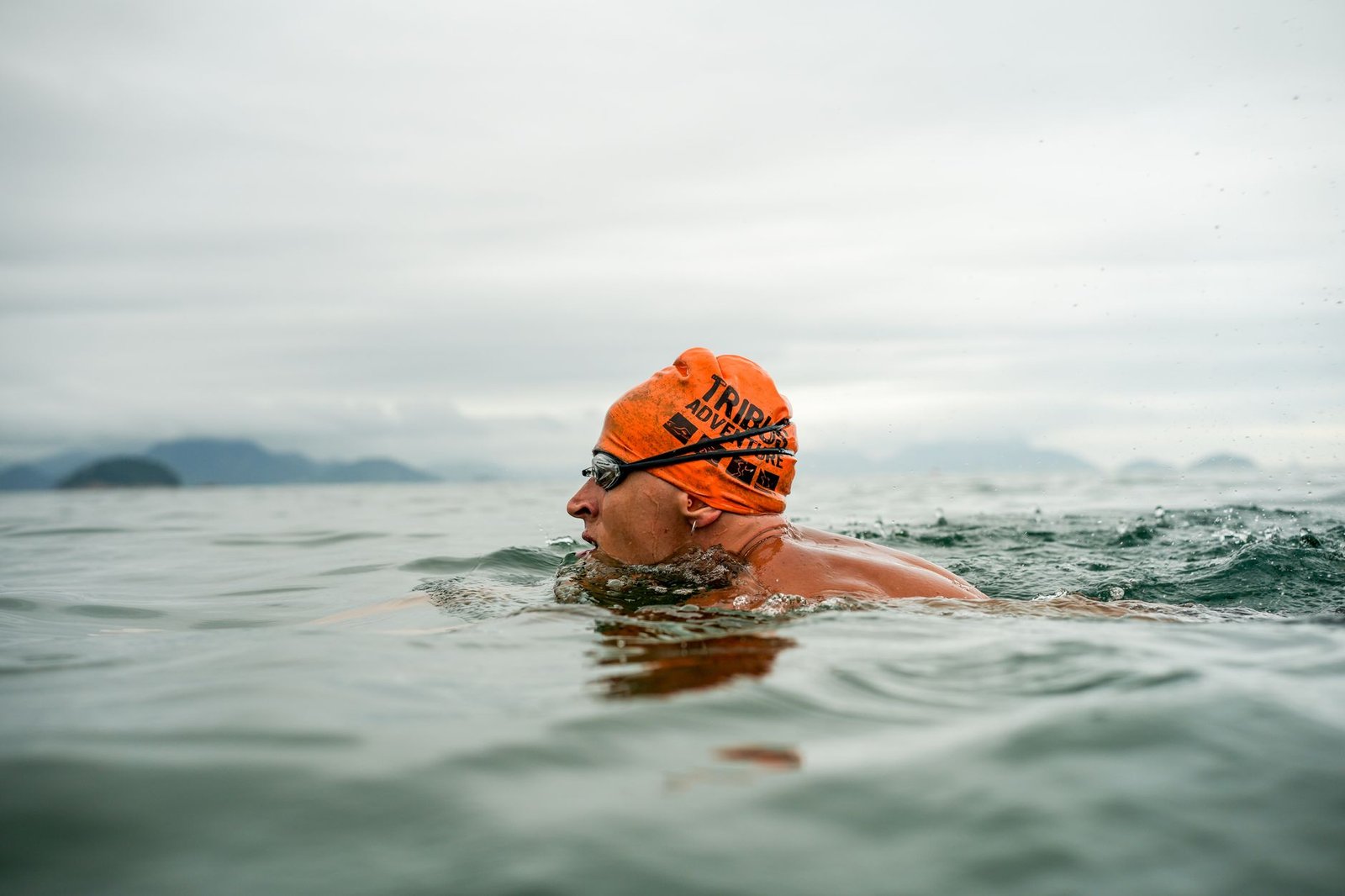 Open water swimmer wearing goggles in saltwater ocean conditions