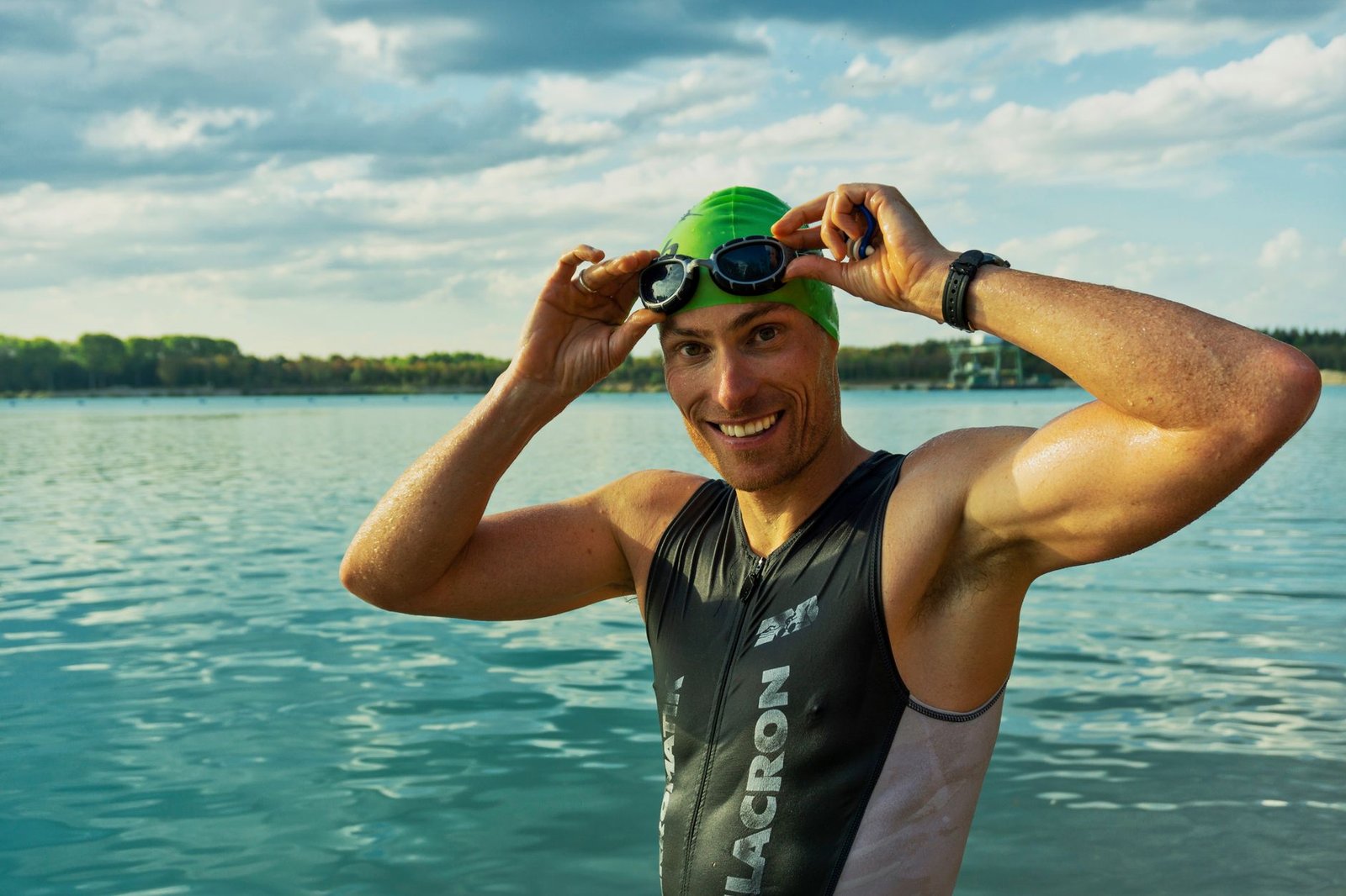 Open water swimmer wearing goggles on a sunny lake or ocean swim