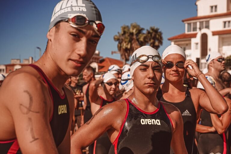 Swimmers wearing goggles before an outdoor race