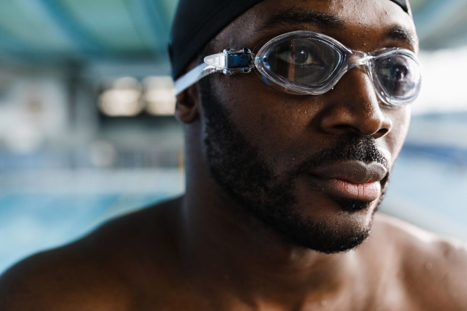 Open-water swimmer adjusting goggles before a longer swim