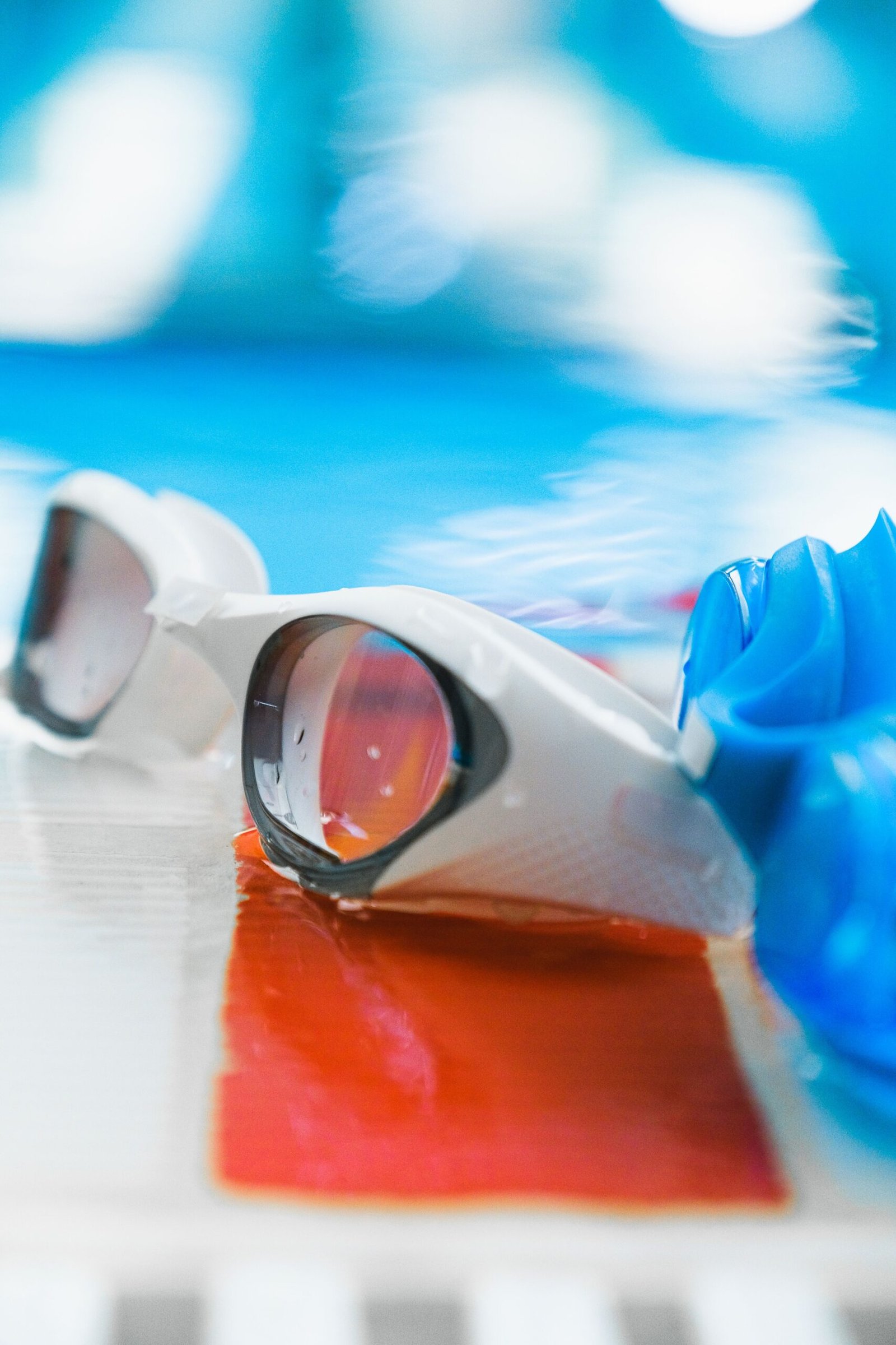 Swimming goggles and cap ready for a vision-correction swim setup