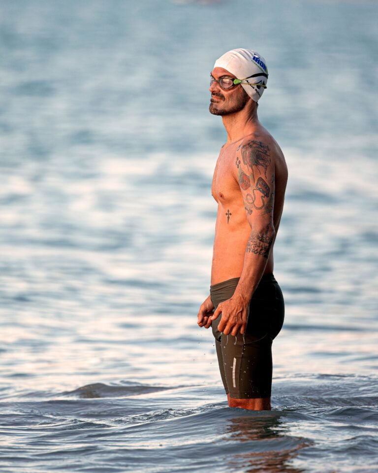 Open-water swimmer wearing goggles before entering the sea